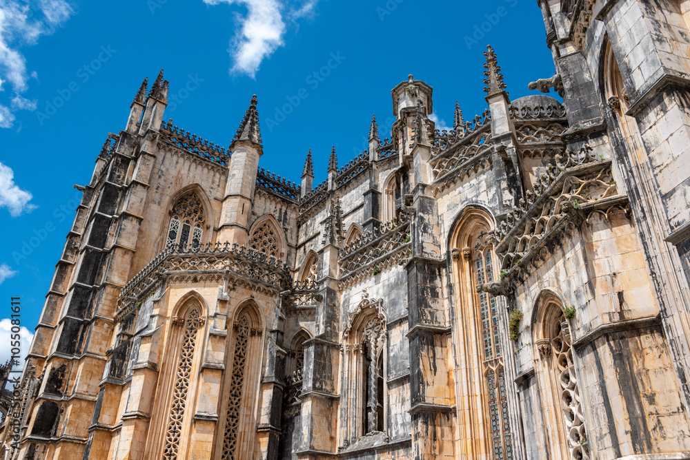 Picturesque facade of medieval Santa Maria da Vitoria monastery church in Batalha, a manueline gothic masterpiece, view on the southern facade Picturesque facade of medieval Santa Maria da Vitoria monastery church in Batalha, a manueline gothic masterpiece, view on the southern facade