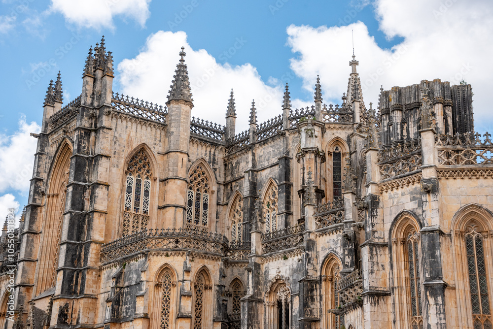 Fototapeta premium Picturesque facade of medieval Santa Maria da Vitoria monastery church in Batalha, a manueline gothic masterpiece, view on the southern facade