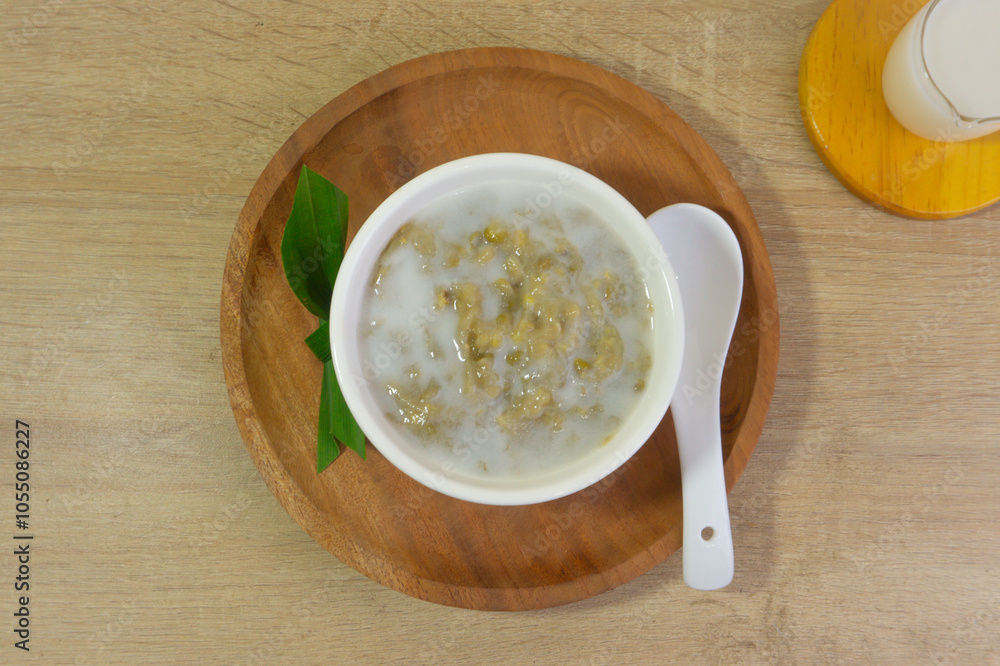Mung Bean Porridge or Bubur Kacang Hijau, Indonesian dessert porridge of mung beans with coconut milk, pandan leaf and ginger. Mung Bean Porridge or Bubur Kacang Hijau, Indonesian dessert porridge of mung beans with coconut milk, pandan leaf and ginger.