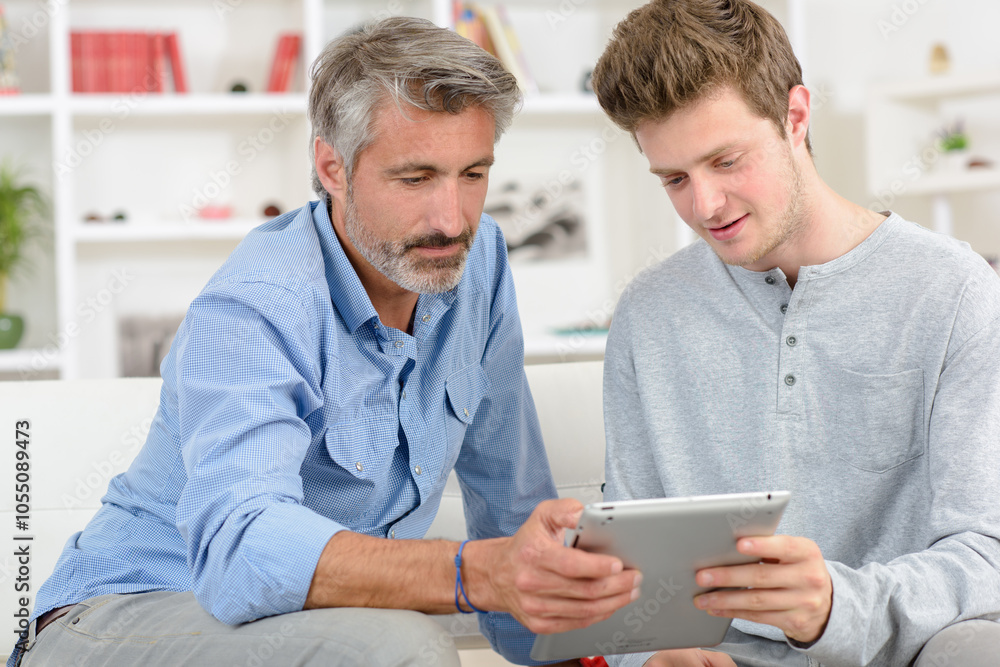 Two men looking at tablet Two men looking at tablet