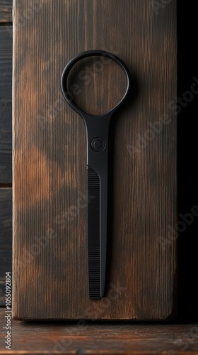Wallpaper Mural Black scissors on a wooden surface, minimalist style, perfect for creative projects or crafting tasks. Torontodigital.ca