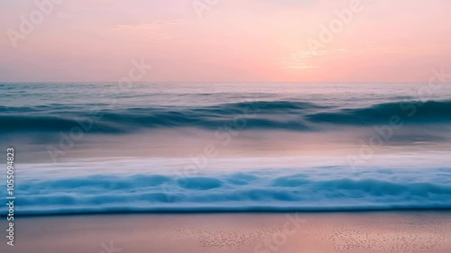 A foamy wave crashes onto the sandy shore at sunset