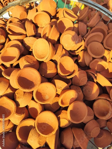 Hand made clay diye for sell in the market on the occasion of dipawali festival in india. Hand made clay diye or earthen lamp lighting in diwali night. People shoping for diwali festival.  photo