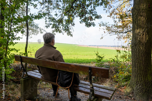 Lonely Senior Old Man Sitting on Bench in Park.