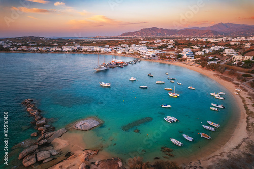 Obraz na płótnie A serene beach on Paros Island, Greece, with golden sands, clear turquoise waters, and gentle waves. Framed by rocky cliffs and lush greenery, it's an idyllic Mediterranean escape under the sun. w salonie