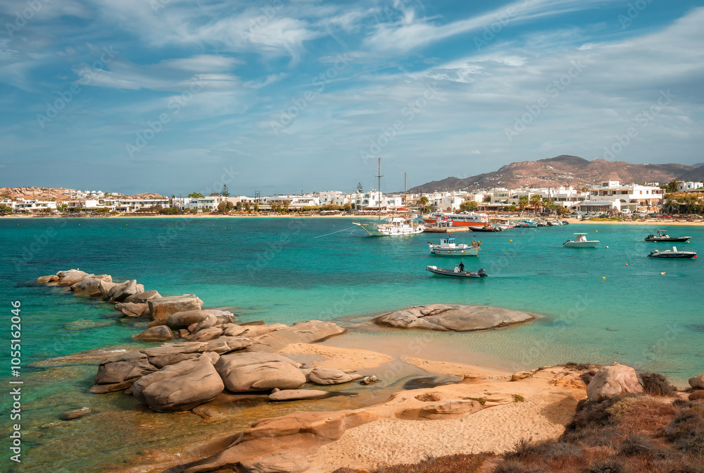 A stunning view of Naxos Island, Greece, featuring crystal-clear turquoise waters, rugged coastlines, and charming white-washed buildings. A picturesque paradise for travelers and sun-seekers.