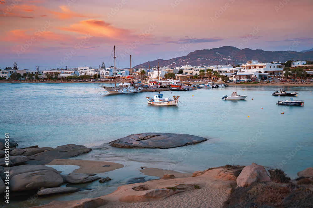 A stunning view of Naxos Island, Greece, featuring crystal-clear turquoise waters, rugged coastlines, and charming white-washed buildings. A picturesque paradise for travelers and sun-seekers.