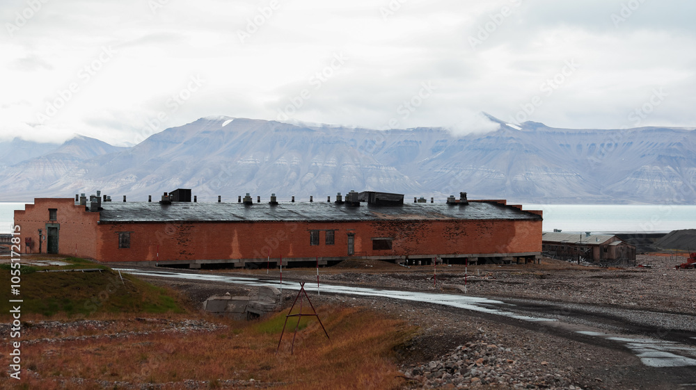 Exploring the abandoned buildings of Pyramiden in Svalbard under cloudy skies Exploring the abandoned buildings of Pyramiden in Svalbard under cloudy skies