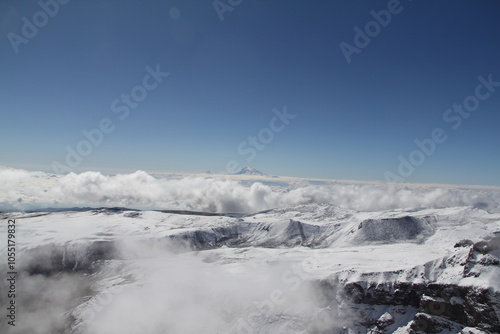 Majestic snow-capped mountain range under clear blue sky, a breathtaking winter wonderland