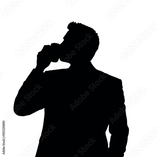A businessman silhouette standing and drinking coffee, with one hand holding a coffee cup near his mouth
