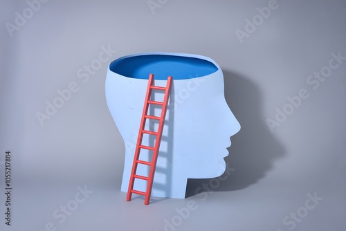 Head shaped hole with red ladder on gray background, symbolizing introspection or escape photo