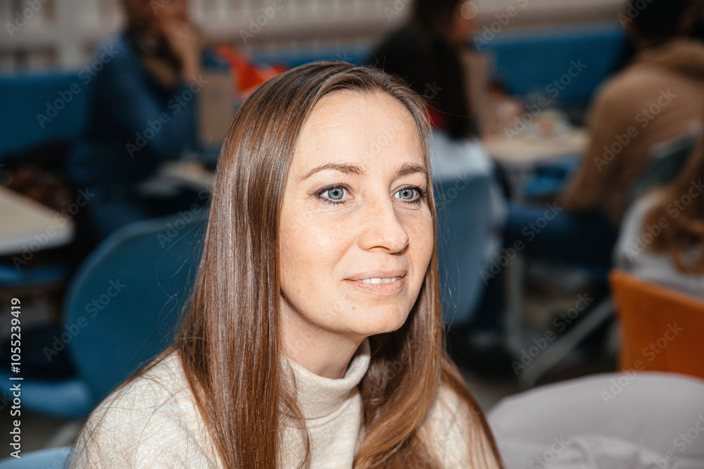 Woman with long hair in a cozy café setting Woman with long hair in a cozy café setting
