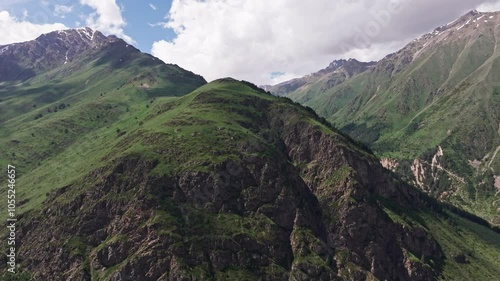 Clouds drifting gracefully over majestic mountain range