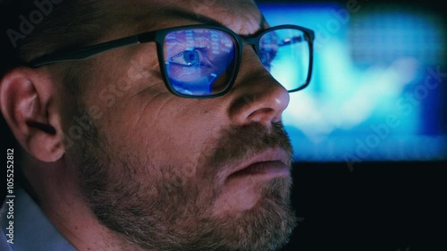 Close-up of stock market analyst working in front of computer screen