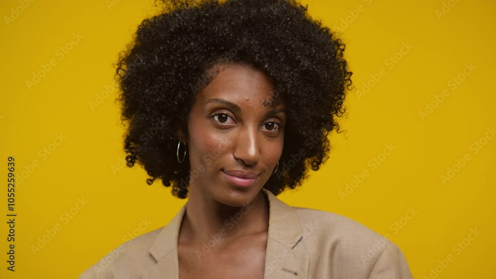 Woman with Curly Hair Posing in Front of Yellow Background Woman with Curly Hair Posing in Front of Yellow Background