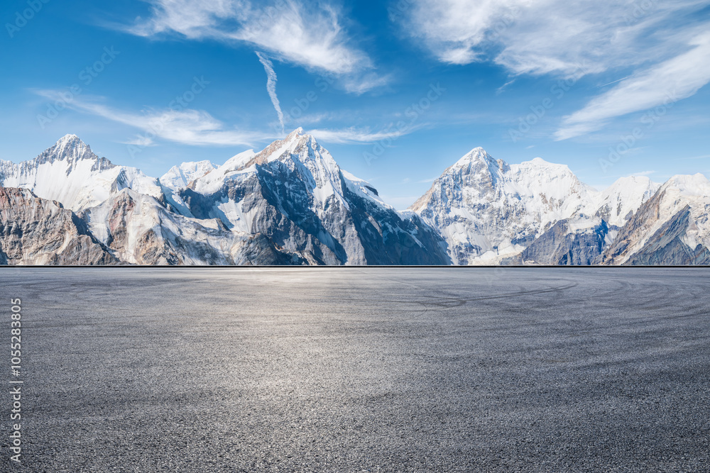 Asphalt road square and snow mountain natural landscape under blue sky. car background.
