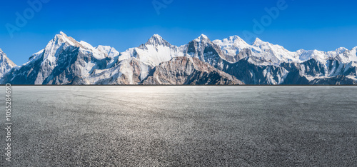 Asphalt road square and snow mountain natural landscape under blue sky. car background.