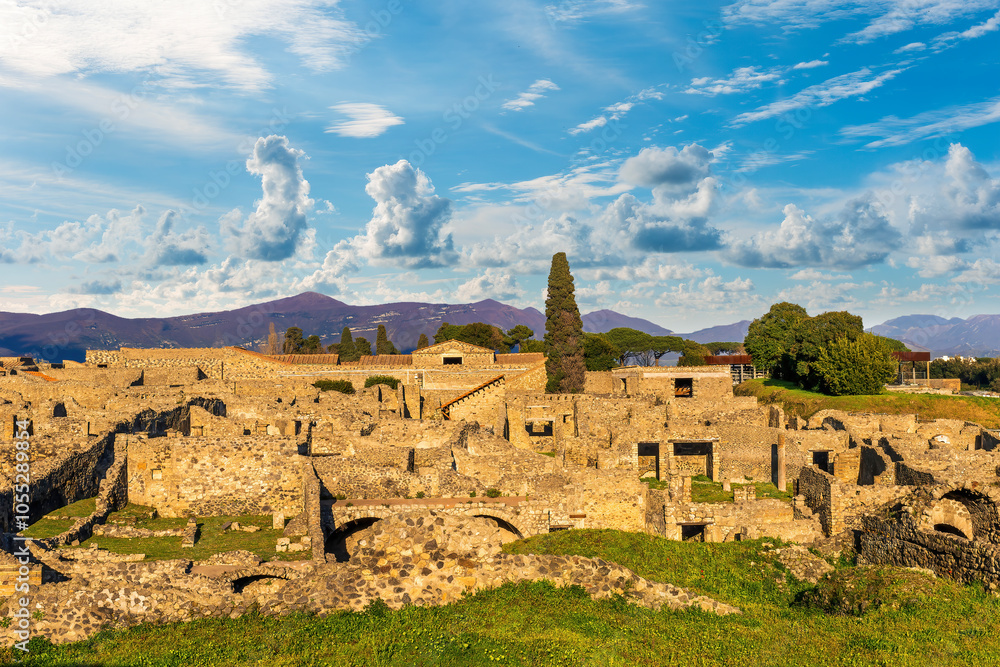 panoramic view of Pompeii ruins in Italy near Naples uotdoor under blue cloudy sky. Landscape of ancient historical town of Roman empire with beautiful valley and mountains on background panoramic view of Pompeii ruins in Italy near Naples uotdoor under blue cloudy sky. Landscape of ancient historical town of Roman empire with beautiful valley and mountains on background