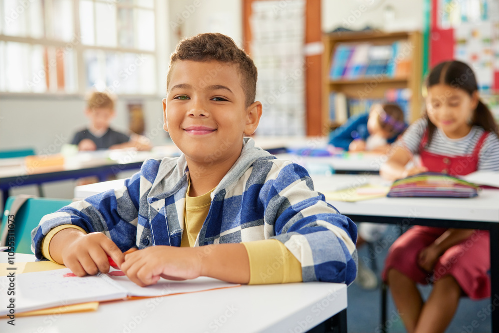 Latin school boy sitting at desk in classroom and smile Latin school boy sitting at desk in classroom and smile