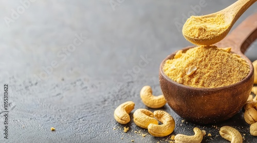Heaping spoonful of nutritional yeast with cashews on a table, vegan ingredients, vegan cheese substitute concept