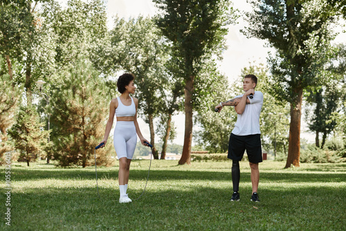 Two friends exercise in a park, showcasing determination and friendship through inclusive fitness.