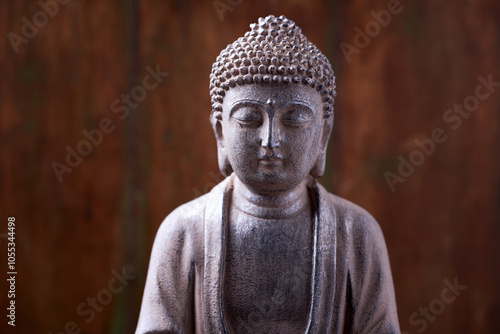 Meditating Buddha Statue on dark background. Close up. Copy space.	