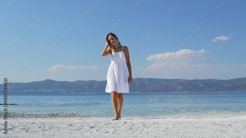 Blonde woman walking on the beach Blonde woman walking on the beach