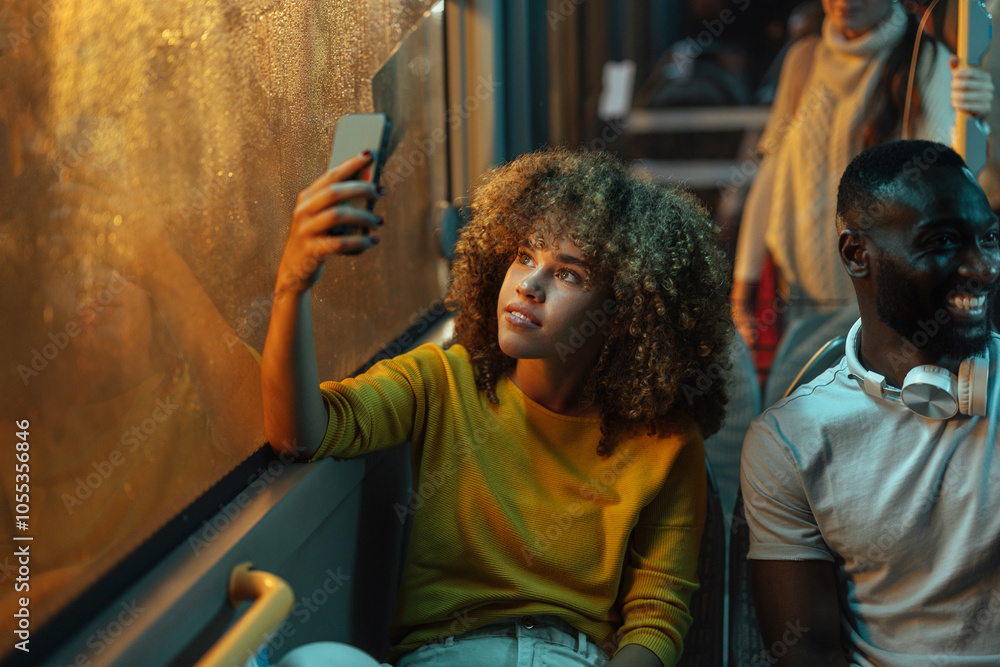 © bernardbodo - Young woman taking a selfie on a bus at night © bernardbodo - Young woman taking a selfie on a bus at night