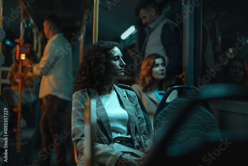 Fotografie Brunette woman in her early 40s sitting on a bus