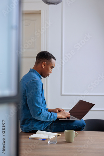 Male worker using his laptop in the office