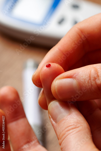 Person using glucometer, checking blood sugar level. Diabetes concept photo