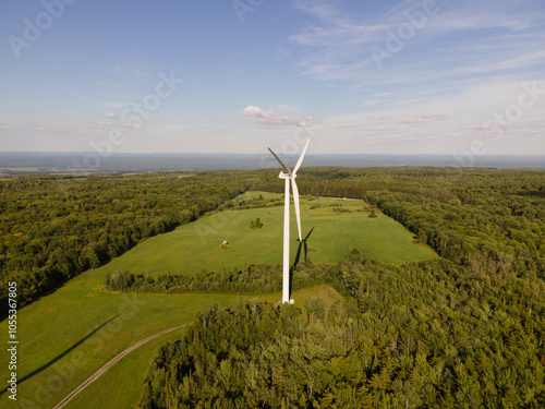 Aerial view of wind turbines in a scenic rural landscape with fields and forests under a cloudy sky, Lowville, United States of America. photo