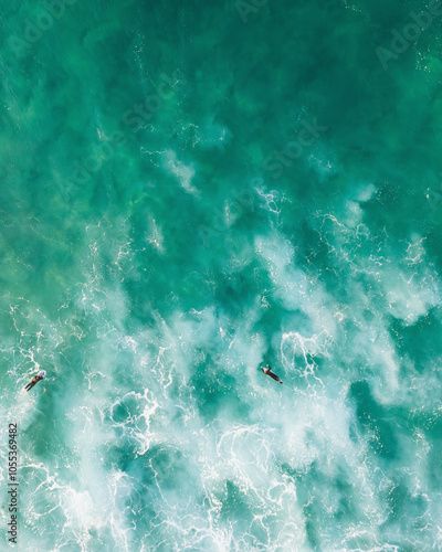 Aerial view of surfers riding waves at Bondi Beach, Sydney, Australia.