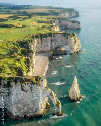 aerial view towards the beach and famous Chalk Cliffs of Etretat - Falaises d’Étretat with Failaise d’Aval and the L'Aiguille (the Needle) and Porte d'Aval Natural Arch at the Normandy Alabaster Coas photo