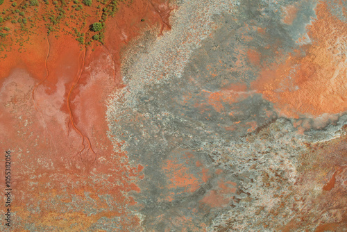 Aerial view of colorful salt pond with unique patterns and rugged terrain, Pilbara Region, Australia. photo