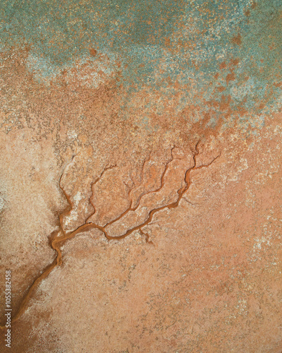 Aerial view of colorful salt pond and creek with natural patterns in rugged terrain, Onslow, Australia. photo