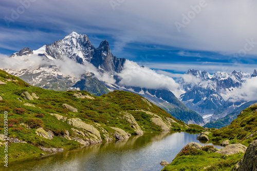 Lake in the Alps. Mountain lake high altitude lagoon surrounded with mountain peaks picturesque landscape of alpine scene in summer. Turquoise water of lagunas in french and italian Alps