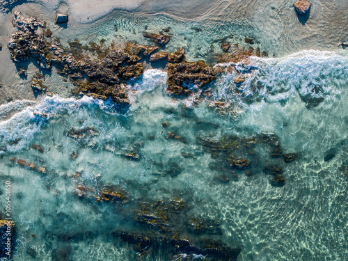 Aerial view of serene sandy beach with turquoise ocean and rocky coastline, Wells, United States. photo