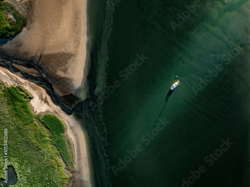 Aerial view of tranquil coastline with boat and sandy beach at low tide, Wells, Maine, United States. photo