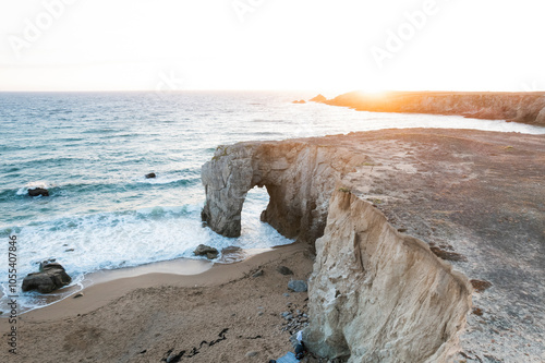 Aerial view of the beautiful natural arch at Port-Blanc with sandy beach and crashing waves, Saint-Pierre-Quiberon, France. photo