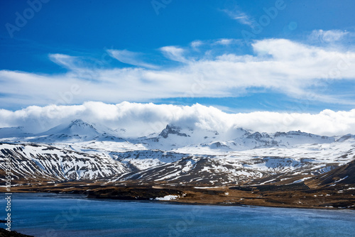 Aerial view of snowy Kolgrafarfjordur fjord with majestic mountains and dramatic clouds, Grundarfjardarbaer, Iceland. photo