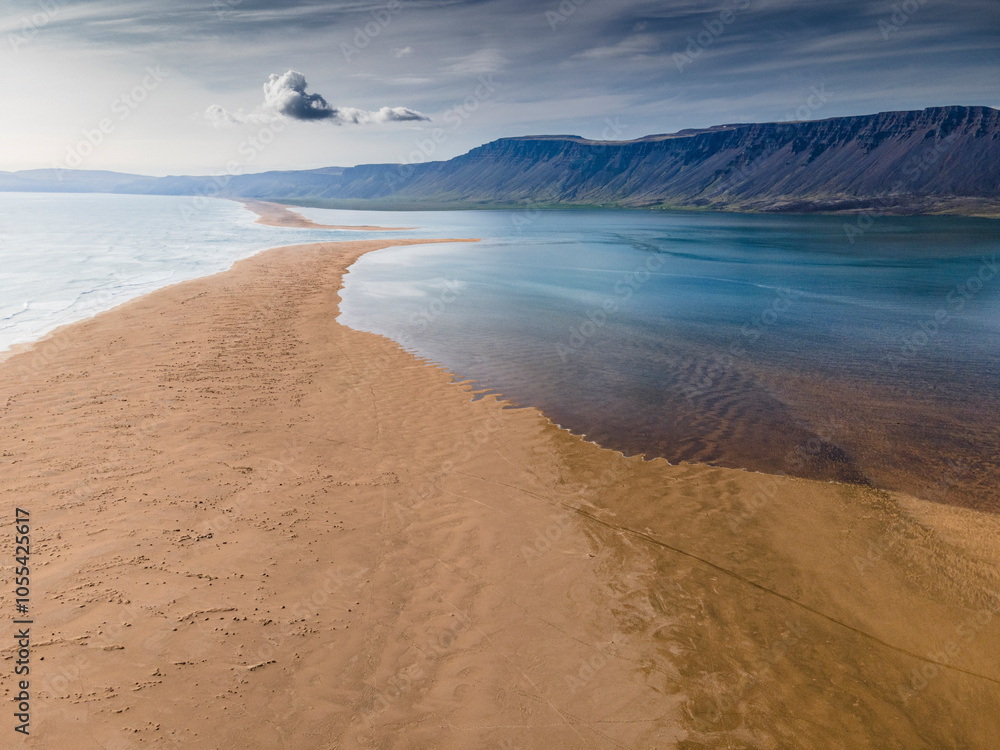 Aerial view of raudisandur beach with tranquil ocean and majestic mountains, patreksfjordur, iceland. Aerial view of raudisandur beach with tranquil ocean and majestic mountains, patreksfjordur, iceland.