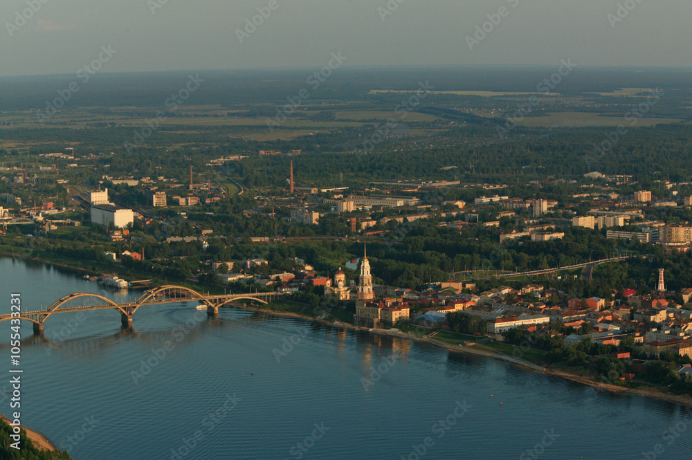 Aerial view of a beautiful cityscape with a serene river crossing and a bridge, Rybinsk, Russia. Aerial view of a beautiful cityscape with a serene river crossing and a bridge, Rybinsk, Russia.