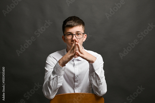 Photos The young leader folded his hands in a steeple gesture.