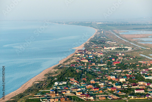 Aerial view of a beautiful coastline with a tranquil village and sandy beach, Golubitskaya, Russia. photo