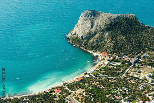 Aerial view of tranquil turquoise sea and sandy beach along a picturesque coastline with mountains, Novyi Svit, Russia. photo