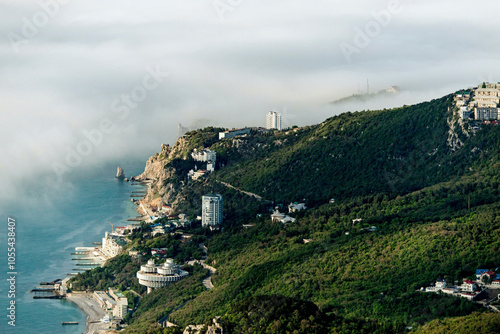 Aerial view of picturesque coastal buildings on a hill overlooking the serene sea, Yalta, Crimea, Russia. photo