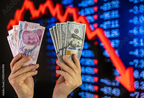 American dollar and Turkish lira on woman's hand and stock market screen, money chart background