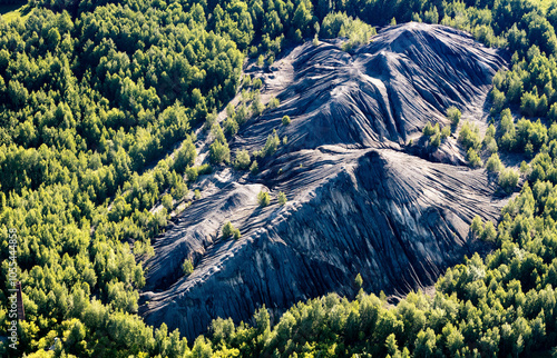 Aerial view of scenic hills and lush forest with coal mining activity, Tula Oblast, Russia. photo