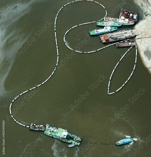 Aerial view of Irtysh River with boats and ships in a beautiful natural landscape, Omsk Oblast, Russia.